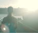 A person jogging along a waterfront path at sunrise, representing the active lifestyle that can benefit from post-workout showers with a shower filter.